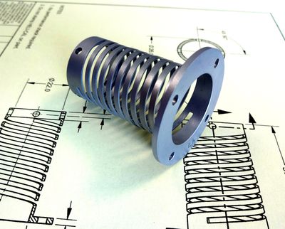 Combined Compression and Extension spring machined from a solid replaces wire wound spring
